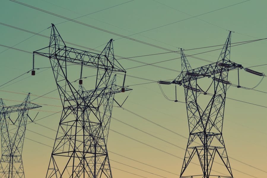 Power lines in front of a clear sky at dawn